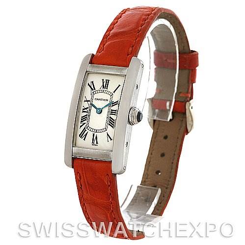 The image shows the Cartier Tank Americaine W2601956 Women
s White Gold Silver Dial W2601956 Women
s White Gold Silver Dial watch at a three-quarter angle, highlighting its face, bezel, and red leather strap.