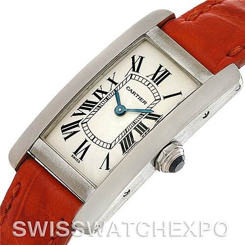 This image shows a Cartier Tank Americaine W2601956 Women
s White Gold Silver Dial W2601956 Women
s White Gold Silver Dial watch at an angle highlighting the face, crown, and part of the red strap.
