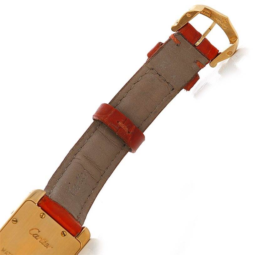 The image shows the clasp, buckle, and part of the leather strap of the Cartier Tank Américaine watch from a back angle.