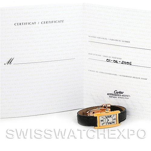 The image shows the Cartier Tank Américaine watch from a front angle, alongside its certificate and paperwork.