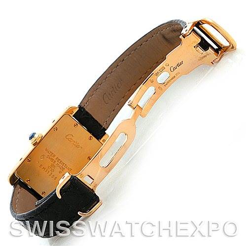 The image shows the back side of a Cartier Tank Americaine W2601956 Women's Yellow Gold Silver Dial W2601956 Women's Yellow Gold Silver Dial watch, focusing on its clasp, leather strap, and case back.