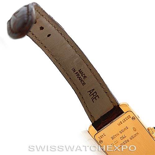 The image shows the back of the strap and the case of a Cartier Tank Américaine watch at an angle.