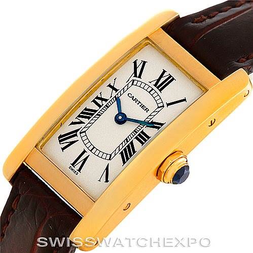 The image displays a Cartier Tank Américaine watch face, showing the dial, hands, bezel, crown, and part of the leather strap at an angled view.