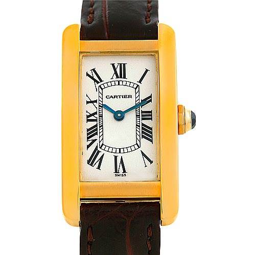 The image shows a front view of a Cartier Tank Americaine W2601956 Women's Yellow Gold Silver Dial W2601956 Women's Yellow Gold Silver Dial watch, showcasing its rectangular face, Roman numerals, and leather strap.