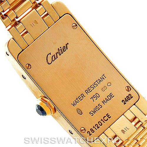 The image shows the back case and part of the bracelet of a Cartier Tank Americaine W26015K2 Women's Yellow Gold Silver Dial W26015K2 Women's Yellow Gold Silver Dial watch.