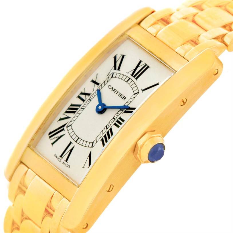 The image shows the Cartier Tank Americaine W26015K2 Women
s Yellow Gold Silver Dial W26015K2 Women
s Yellow Gold Silver Dial watch from a close-up side angle, highlighting the face, crown, and part of the bracelet.