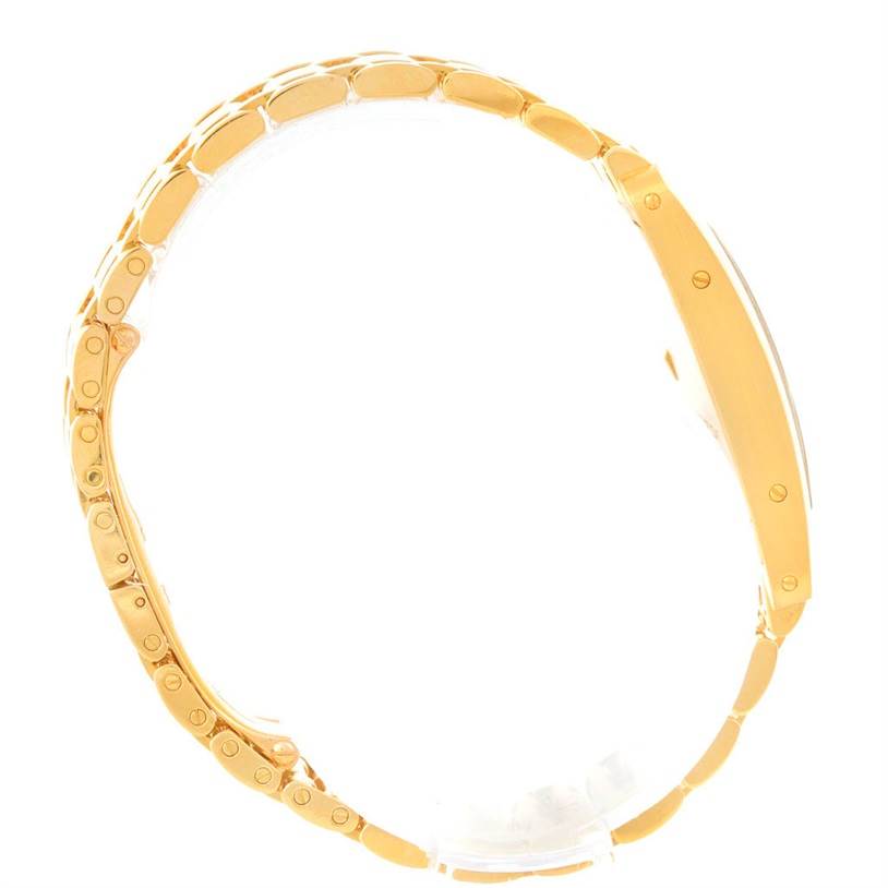 This image shows a side angle view of the Cartier Tank Americaine W26015K2 Women
s Yellow Gold Silver Dial W26015K2 Women
s Yellow Gold Silver Dial watch, highlighting its bracelet and side profile.