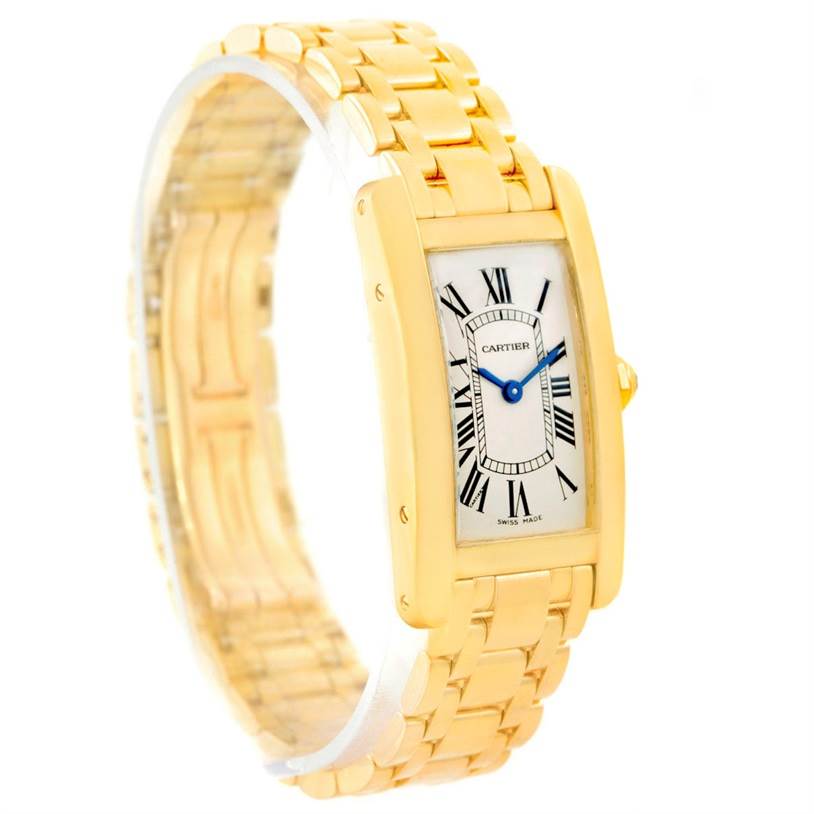 The Cartier Tank Americaine W26015K2 Women
s Yellow Gold Silver Dial W26015K2 Women
s Yellow Gold Silver Dial watch is shown at a slight angle, displaying both the face with Roman numerals and its gold link bracelet.