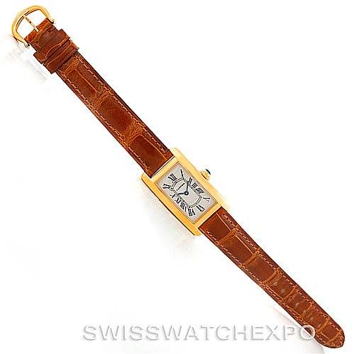 The image shows a top view of a Cartier Tank Americaine W2601956 Women's Yellow Gold Silver Dial W2601956 Women's Yellow Gold Silver Dial watch with a brown leather strap and gold accents.