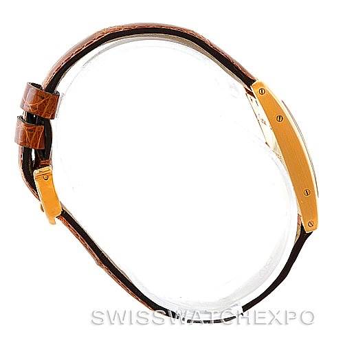 The image shows a side profile of the Cartier Tank Americaine W2601956 Women's Yellow Gold Silver Dial W2601956 Women's Yellow Gold Silver Dial watch, highlighting the case and the brown leather strap with a buckle.