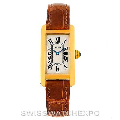 This image shows a Cartier Tank Americaine W2601956 Women's Yellow Gold Silver Dial W2601956 Women's Yellow Gold Silver Dial watch with a gold case, brown leather strap, and Roman numeral dial.
