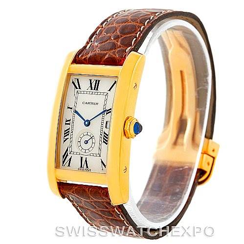 The Cartier Tank Americaine W2600351 Women's Yellow Gold Silver Dial W2600351 Women's Yellow Gold Silver Dial watch is shown at a slight angle, displaying the dial, case, crown with blue cabochon, and brown leather strap.