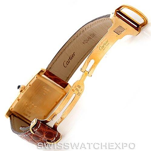 This image shows the open deployant clasp and leather strap of a Cartier Tank Américaine watch.