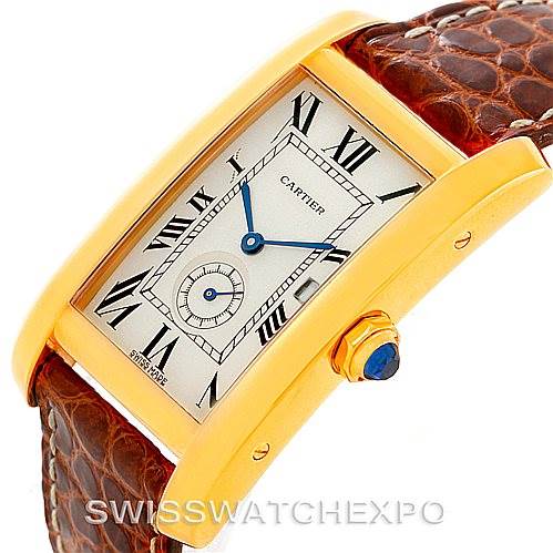 The photo shows a Tank Americaine by Cartier at a 3/4 angle, illustrating the watch face, crown, and leather strap.