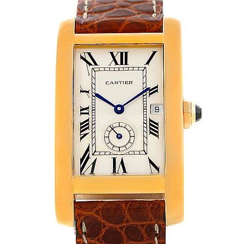 The image shows a front view of a Cartier Tank Americaine W2600351 Women's Yellow Gold Silver Dial W2600351 Women's Yellow Gold Silver Dial watch with a rectangular dial, Roman numerals, blue hands, and a brown leather strap.