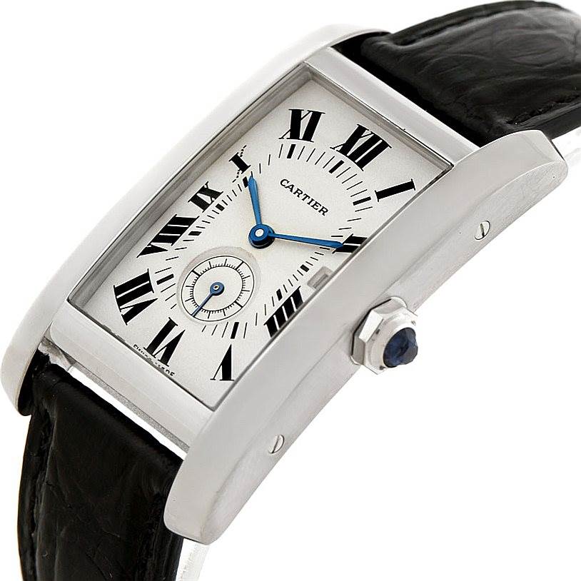 This image shows a Cartier Tank Americaine Women
s White Gold Silver Dial Women
s White Gold Silver Dial watch at an oblique angle, highlighting the dial, case, crown, and part of the leather strap.