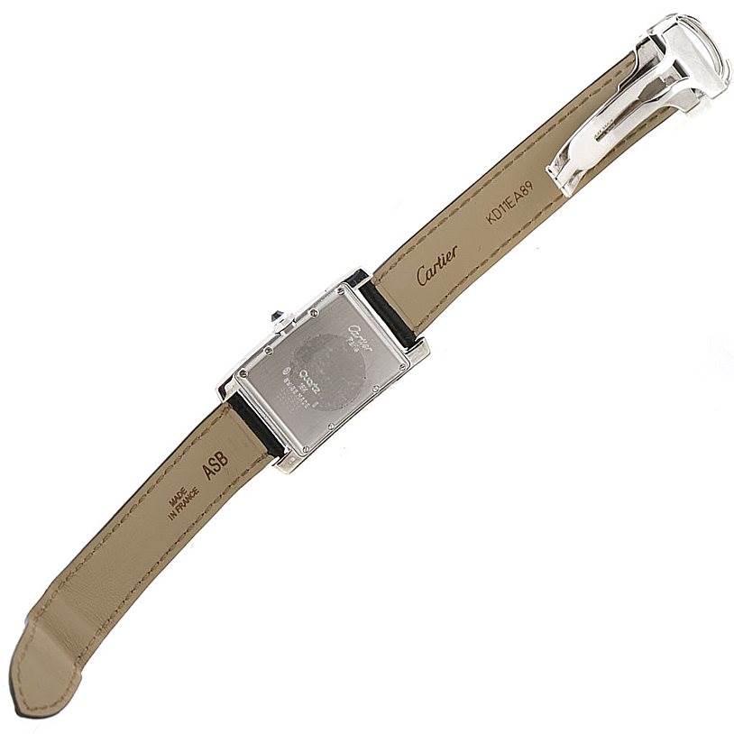The image shows the back view of a Cartier Tank Américaine watch, displaying its case back, strap, and buckle.