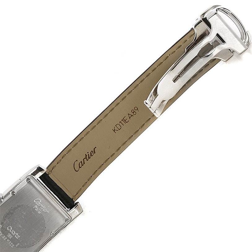 The image shows the underside of the strap and clasp of a Cartier Tank Americaine Women
s White Gold Silver Dial Women
s White Gold Silver Dial watch, including part of the case back.