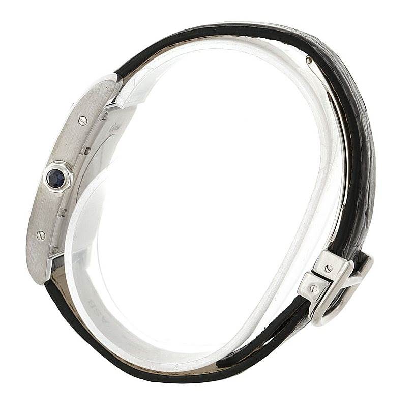 The Cartier Tank Americaine Women
s White Gold Silver Dial Women
s White Gold Silver Dial watch is shown from a side view, displaying the case, crown, and strap.