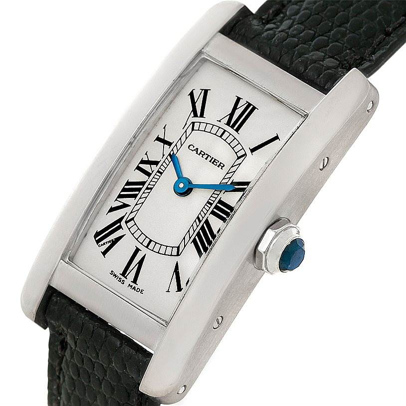 The image shows a close-up view of the face and side of a Cartier Tank Americaine W2601956 Women
s White Gold Silver Dial W2601956 Women
s White Gold Silver Dial watch, highlighting its rectangular dial and crown.