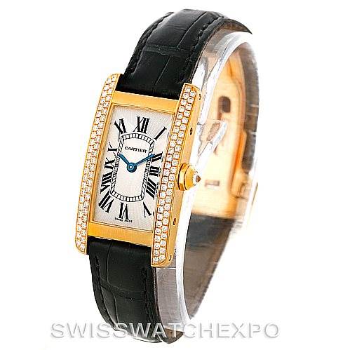 The image shows a Cartier Tank Americaine W2601956 Women's Yellow Gold Silver Dial W2601956 Women's Yellow Gold Silver Dial watch from an angled view, highlighting its face, black strap, and diamond-encrusted bezel.