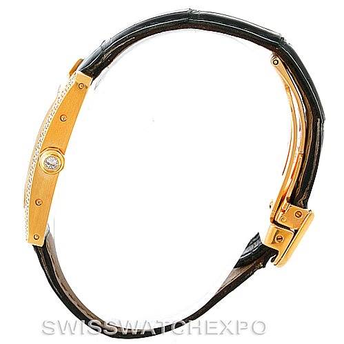 The image shows a Cartier Tank Américaine watch from a side angle, highlighting the case, crown, and leather strap.