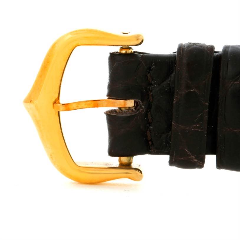 This image shows a close-up of the buckle and leather strap of a Cartier Tank Americaine W2601956 Women's Yellow Gold Silver Dial W2601956 Women's Yellow Gold Silver Dial watch.