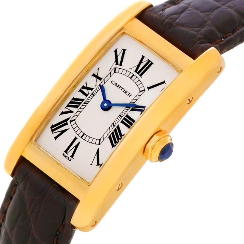 This image shows a Cartier Tank Américaine watch at an angled side view, highlighting its gold case, crown, and leather strap.
