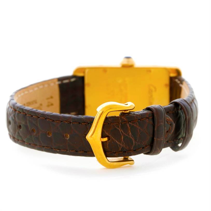 The image shows the rear view of the Cartier Tank Americaine W2601956 Women's Yellow Gold Silver Dial W2601956 Women's Yellow Gold Silver Dial watch, focusing on the brown leather strap and gold buckle.