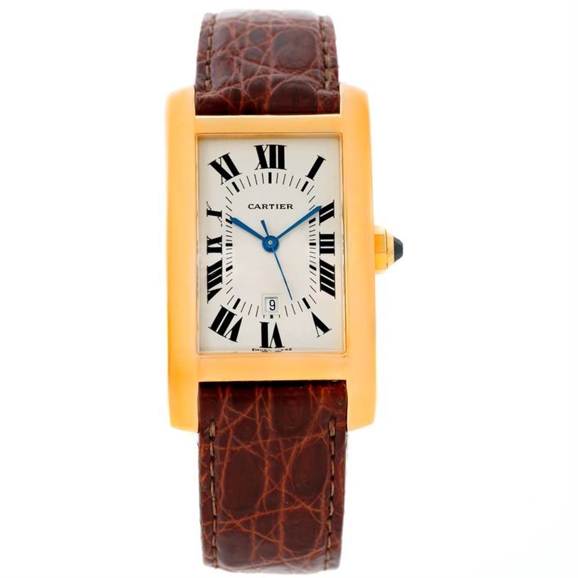 The image shows a front view of a Cartier Tank Américaine watch, highlighting its brown leather strap, rectangular gold case, and Roman numeral dial.