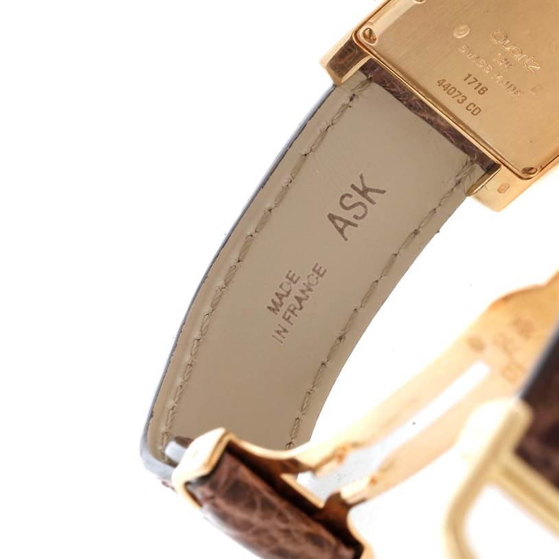 This image shows a close-up angle of the strap and clasp of a Cartier Tank Americaine W2600351 Yellow Gold Silver Dial W2600351 Yellow Gold Silver Dial watch, highlighting the "MADE IN FRANCE" engraving.