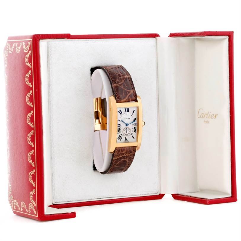 The Cartier Tank Americaine W2600351 Yellow Gold Silver Dial W2600351 Yellow Gold Silver Dial watch is displayed inside its red and white box showing the face, strap, and part of the gold case.