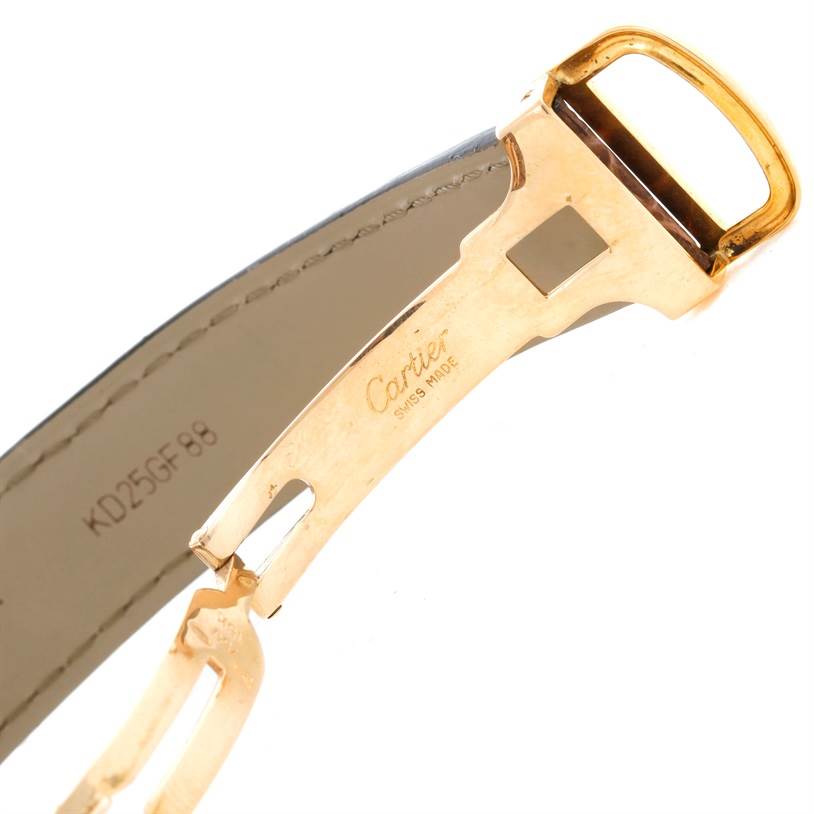 The image shows a close-up of the clasp and part of the strap of the Cartier Tank Americaine W2600351 Yellow Gold Silver Dial W2600351 Yellow Gold Silver Dial watch.
