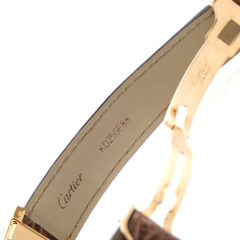 This image shows the inside view of the strap and clasp of the Cartier Tank Americaine W2600351 Yellow Gold Silver Dial W2600351 Yellow Gold Silver Dial watch, featuring brand inscriptions and serial number.