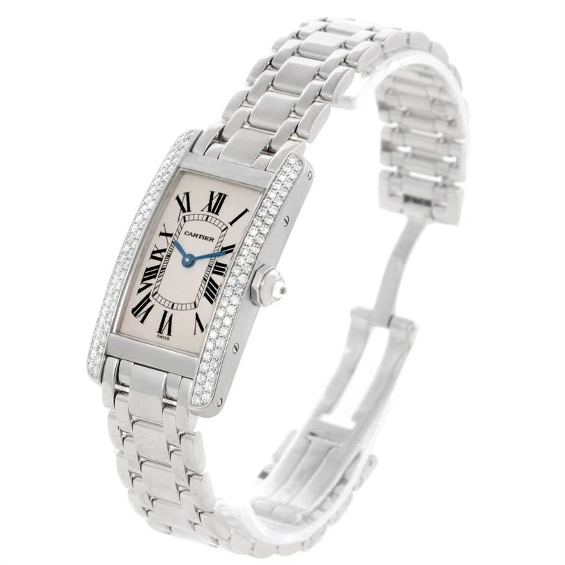 This image shows a Cartier Tank Americaine W2601956 Women
s White Gold Silver Dial W2601956 Women
s White Gold Silver Dial watch at an angle, highlighting its face, bezel, crown, and metal bracelet.