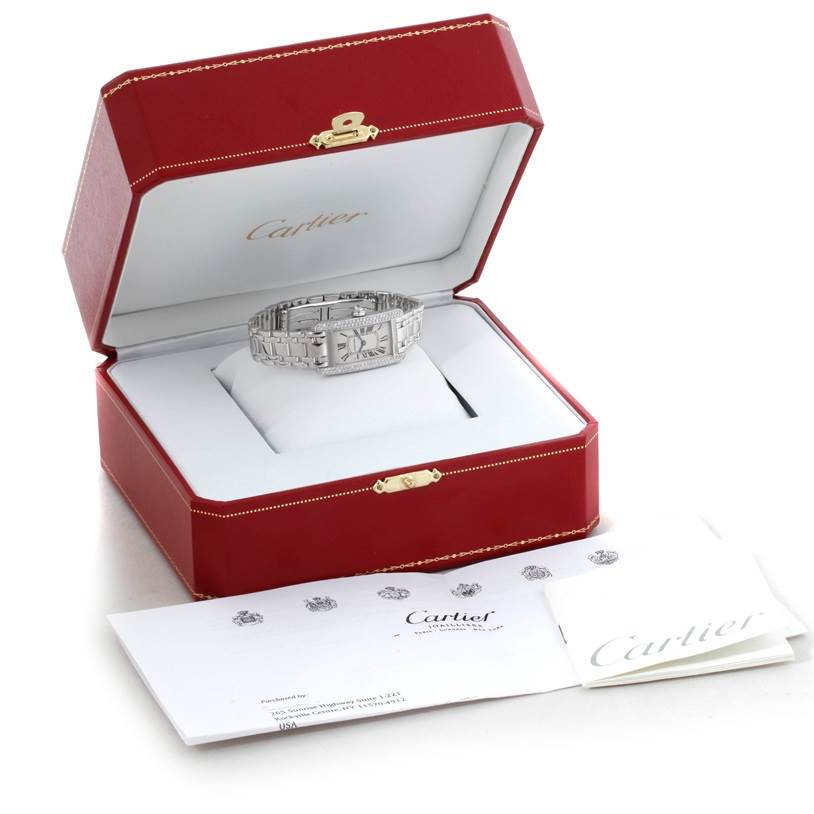 The Cartier Tank Americaine W2601956 Women
s White Gold Silver Dial W2601956 Women
s White Gold Silver Dial watch is displayed inside an open red jewelry box with accompanying paperwork.