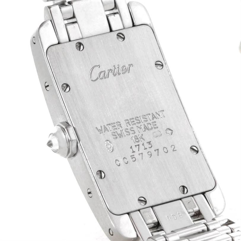 This image shows the back case and part of the bracelet of a Cartier Tank Americaine W2601956 Women
s White Gold Silver Dial W2601956 Women
s White Gold Silver Dial watch at an angle.