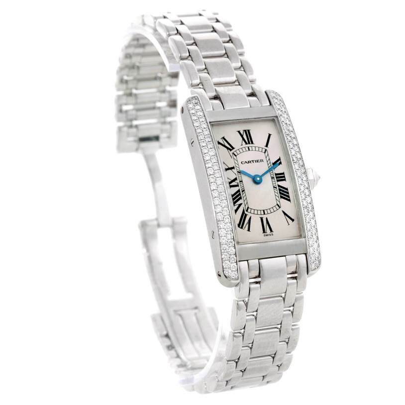The image shows a Cartier Tank Americaine W2601956 Women
s White Gold Silver Dial W2601956 Women
s White Gold Silver Dial watch angled to display the face, bracelet, and side view of the case with diamond accents.