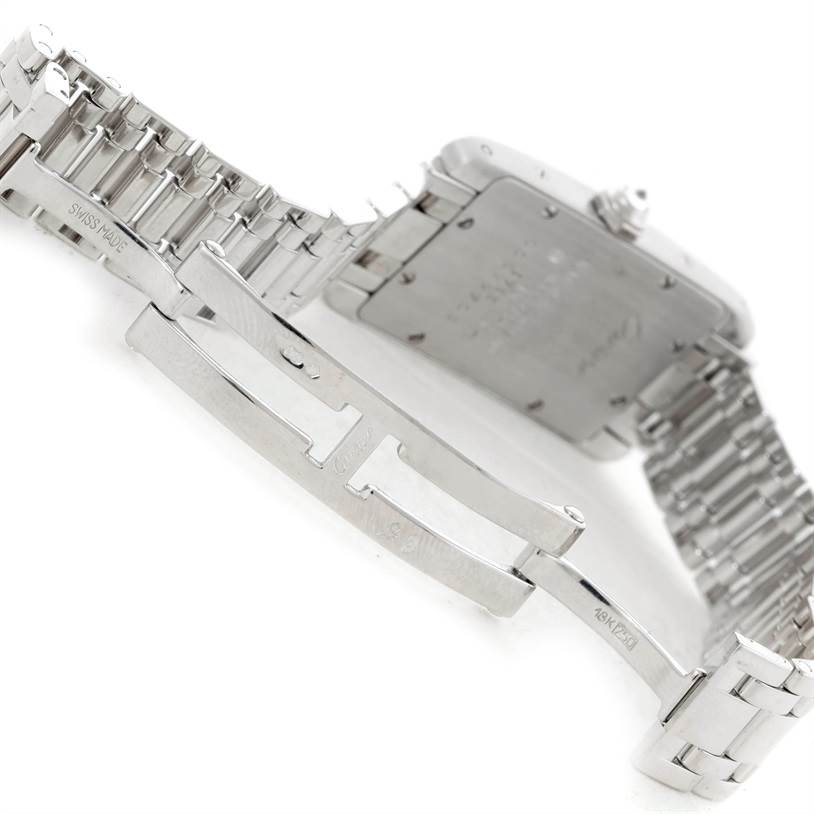 The image shows the back and partially open clasp of the Cartier Tank Americaine W2601956 Women
s White Gold Silver Dial W2601956 Women
s White Gold Silver Dial watch, highlighting the stainless steel bracelet.