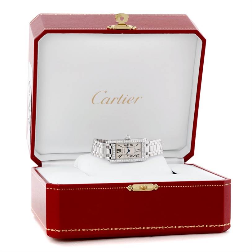 The Cartier Tank Americaine WB707331 Women
s White Gold Silver Dial WB707331 Women
s White Gold Silver Dial watch is displayed front-facing inside its red presentation box.