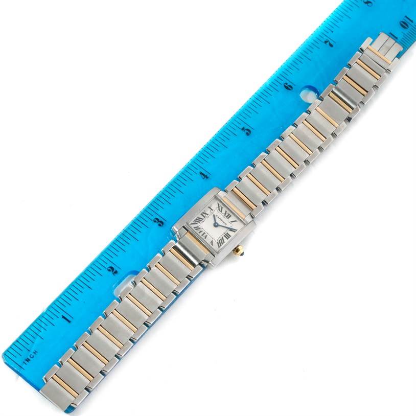 The Cartier Tank Française watch is shown from a top view with a clear display of its face and full bracelet next to a ruler.