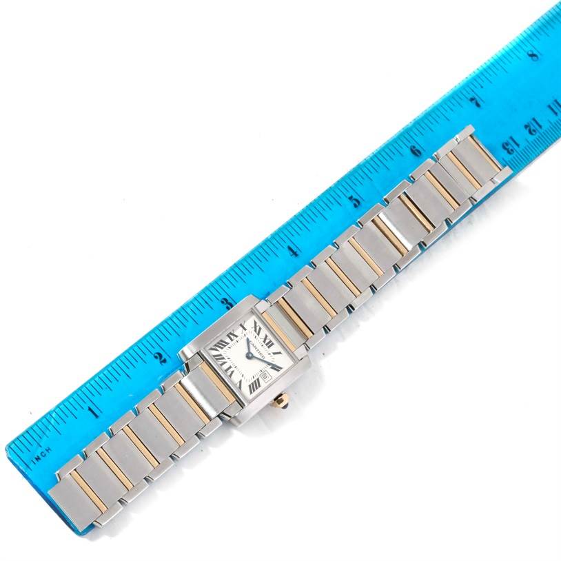The Cartier Tank Francaise W51012Q4 Women's Steel and Gold (two tone) Silver Dial W51012Q4 Women's Steel and Gold (two tone) Silver Dial watch is shown from a top-down angle, featuring its face and the linked bracelet aligned with a ruler.