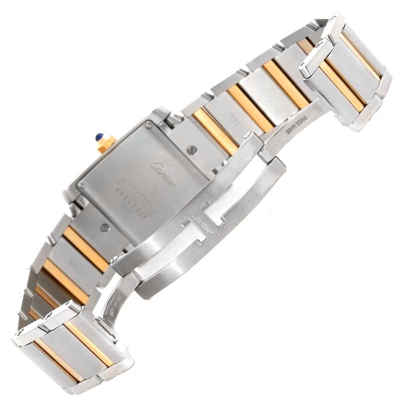 The image shows the back case and the clasp mechanism of a Cartier Tank Francaise W51012Q4 Women's Steel and Gold (two tone) Silver Dial W51012Q4 Women's Steel and Gold (two tone) Silver Dial watch along with its two-tone bracelet.