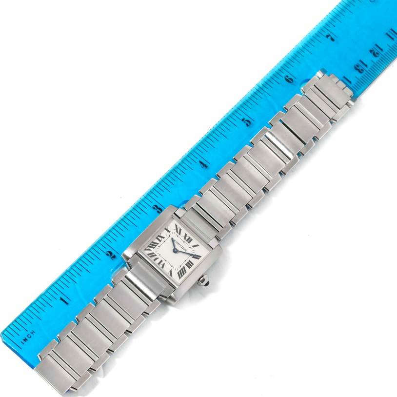 The image shows a Cartier Tank Française watch laid flat with a ruler beside it.