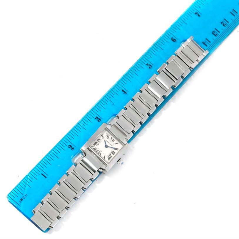 The Cartier Tank Francaise W51008Q3 Women's Stainless Steel Silver Dial W51008Q3 Women's Stainless Steel Silver Dial watch is shown with a full view of its bracelet alongside a ruler for scale.