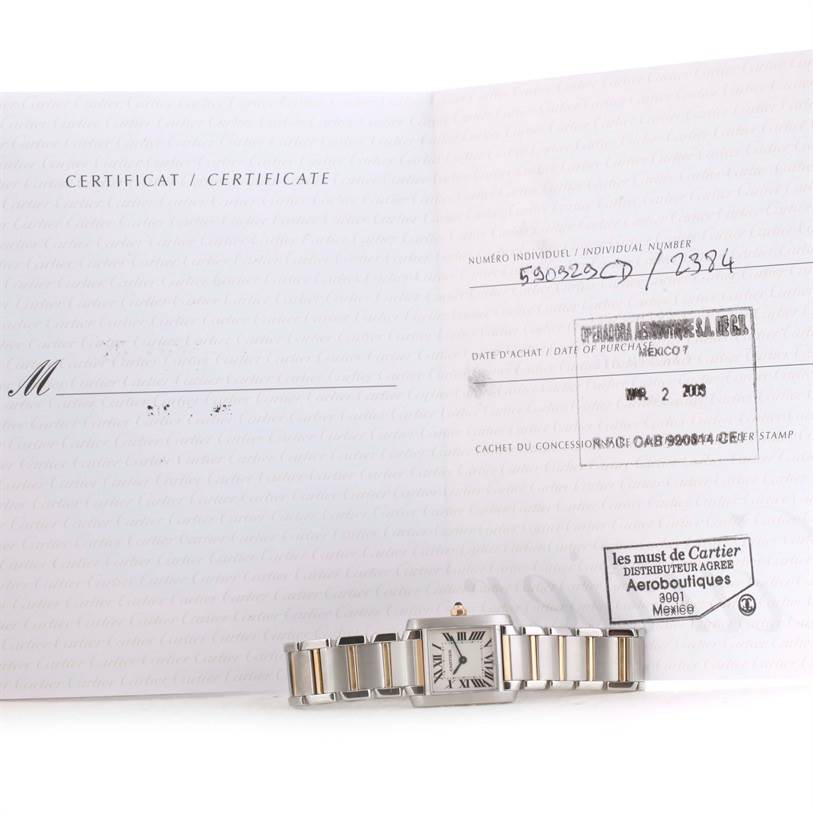 The image shows a Cartier Tank Française watch laid flat, along with its certificate and warranty card.