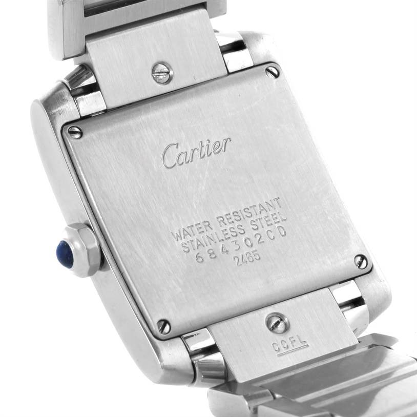 The image shows the back case and part of the bracelet of a Cartier Tank Francaise W51011Q3 Women's Stainless Steel Silver Dial W51011Q3 Women's Stainless Steel Silver Dial watch, highlighting the stainless steel back and inscriptions.