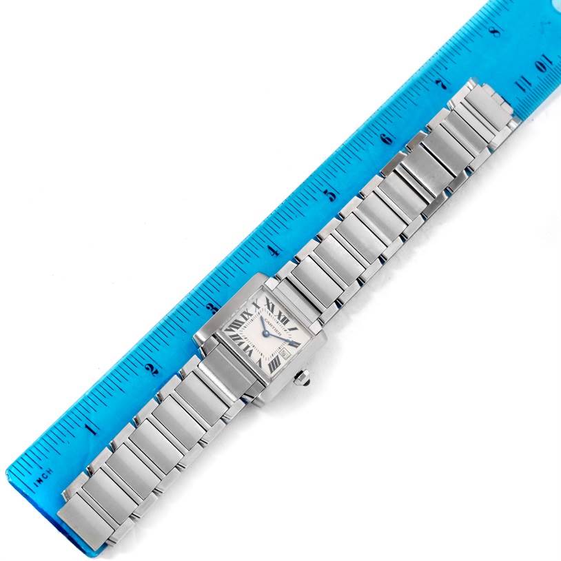 This image shows a Cartier Tank Francaise W51011Q3 Women's Stainless Steel Silver Dial W51011Q3 Women's Stainless Steel Silver Dial watch laid flat next to a blue ruler for size reference.