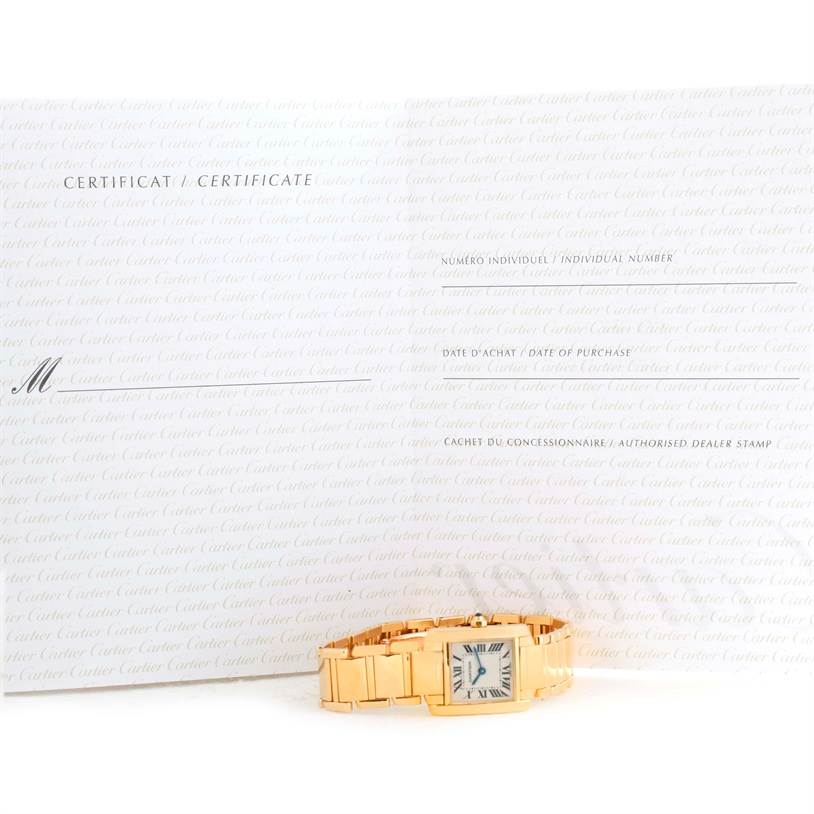 The Cartier Tank Francaise W50002N2 Women's Yellow Gold Silver Dial W50002N2 Women's Yellow Gold Silver Dial watch is shown from the front, with its certificate of authenticity displayed behind it.