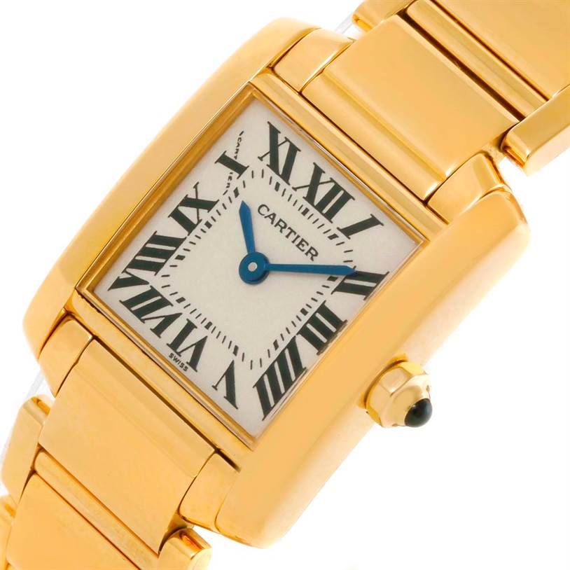 The angled view of the Cartier Tank Francaise W50002N2 Women's Yellow Gold Silver Dial W50002N2 Women's Yellow Gold Silver Dial shows the face, gold case, bracelet, and crown with a blue cabochon.